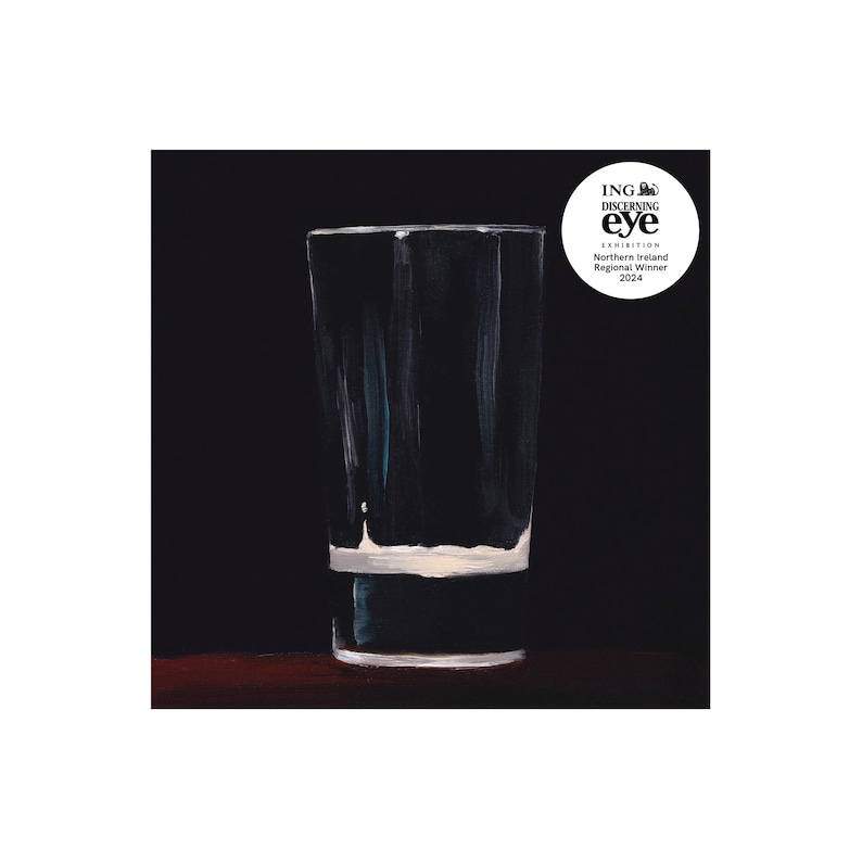 May include: A clear, tall glass with a white base and a dark background. The glass is painted with visible brushstrokes, and the image includes a circular logo with text that reads "ING Discerning Eye Exhibition Northern Ireland Regional Winner 2024."