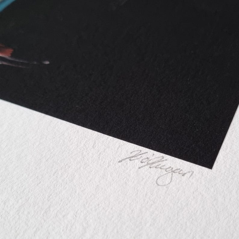 May include: A black artwork with a textured surface, signed in silver ink. The artwork is set against a white background, with a corner view showcasing the contrast between the two surfaces.