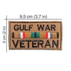 May include: A rectangular patch, 3.7 inches wide and 2 inches tall, with the words "GULF WAR VETERAN" embroidered in black on a tan background. A colorful ribbon design is centered above the word "VETERAN".