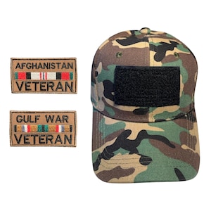 May include: Camouflage baseball cap with a black patch and two patches that read "AFGHANISTAN VETERAN" and "GULF WAR VETERAN". The cap features a green, brown, and tan pattern.