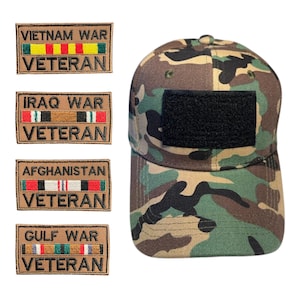 May include: Camouflage baseball cap with a black patch and four patches with the text "VIETNAM WAR VETERAN", "IRAQ WAR VETERAN", "AFGHANISTAN VETERAN", and "GULF WAR VETERAN". The patches have colored stripes.