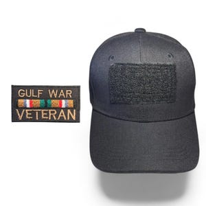 May include: Black baseball cap with a hook and loop patch and a separate patch that reads "GULF WAR VETERAN" with ribbons. The cap has a structured crown and a curved brim. The patches have gold, red, green, and white accents.