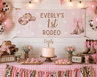 May include: A pink and white party display featuring a banner that reads Everly's 1st Rodeo, a cake with an Everly 1 topper, cowboy boots, hats, and balloons. The setup includes wooden crates, floral arrangements, and signs saying Yeehaw and Howdy.