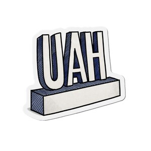 May include: A white sticker with the word "UAH" in bold, outlined letters. The letters are white with blue shading, and sit atop a white and blue rectangular base. The design has a hand-drawn, textured appearance.