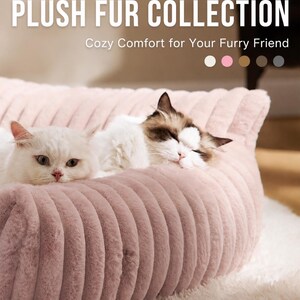 May include: A light pink, ribbed plush pet bed featuring a soft, textured surface. The text PLUSH FUR COLLECTION and Cozy Comfort for Your Furry Friend appear at the top, alongside five small colored circles representing available color options.