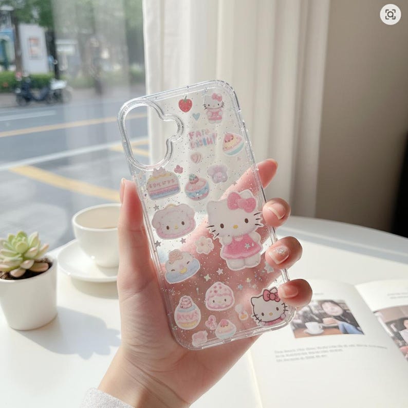 May include: Clear phone case featuring Hello Kitty and various desserts. The case has a glittery effect and includes the text "Fairytale". The design incorporates pink, white, and blue colors, creating a cute and playful aesthetic.