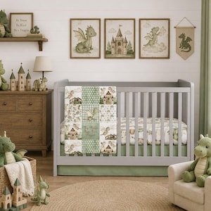 May include: A gray wooden crib featuring a patchwork quilt with dragon and castle illustrations, a green bed skirt, and a matching fitted sheet. The room includes green dragon plush toys, a woven basket, a wooden castle, and framed wall art.