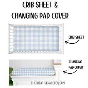 May include: A white crib with a blue and white gingham crib sheet and a matching changing pad cover. The text "CRIB SHEET" and "CHANGING PAD COVER" are written above the crib and changing pad, respectively.