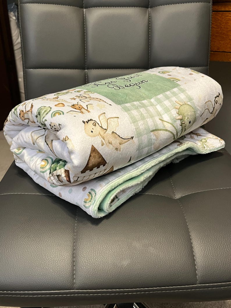 Dragon Baby Blanket: Fantasy Themed Nursery, Soft Minky Crib Comforter
Dragon minky baby blanket, shown as in the comforter option with sage green minky. Blanket size 35x52 inches. Blanket is handmade in Kansas, USA. You can pick the back minky color. 
Dragon Baby Blanket Handmade Baby Quilt Fantasy Baby Nursery Bedding Baby Shower Gift Newborn Boy Room Decor Fairy Tale Crib Comforter