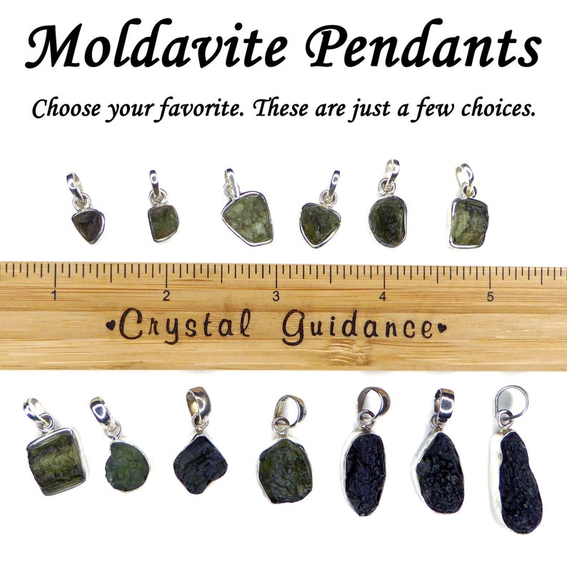 May include: A collection of 10 Moldavite pendants, some with a green hue and others with a dark green to black hue. The pendants are displayed on a wooden ruler with the text "Crystal Guidance" printed on it. Choose your favorite.