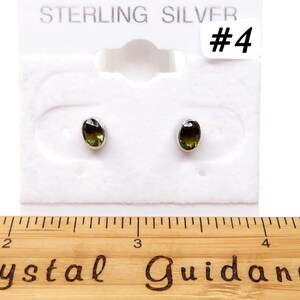 May include: Sterling silver earrings with green oval gemstones. The earrings are displayed on a white card with the text "STERLING SILVER #4".