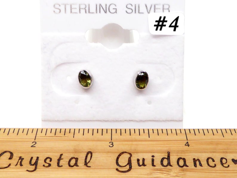 May include: Sterling silver earrings with green oval gemstones. The earrings are displayed on a white card with the text "STERLING SILVER #4".