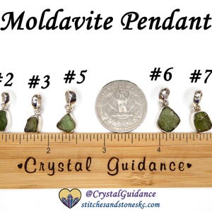 May include: Five silver pendants with green moldavite stones, numbered 2, 3, 5, 6, and 7. The pendants are arranged in a row on a wooden ruler with a "Crystal Guidance" logo.