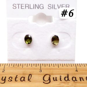 May include: Sterling silver earrings with oval-shaped green gemstones. The earrings are displayed on a white card with the text "Sterling Silver #6".