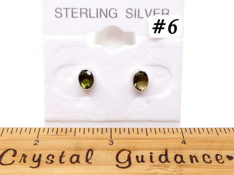 May include: Sterling silver earrings with oval-shaped green gemstones. The earrings are displayed on a white card with the text "Sterling Silver #6".