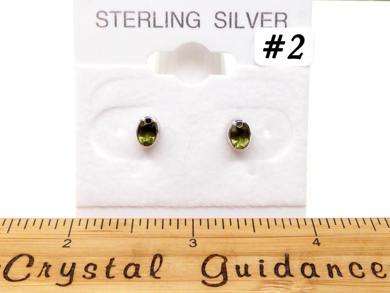 May include: Sterling silver earrings with green oval gemstones on a white card with the text "STERLING SILVER #2".