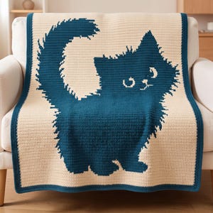 May include: A rectangular crochet blanket featuring a cream-colored background with a large, dark teal cat silhouette in the center. The cat has a fluffy, textured appearance with a long, curved tail and a matching dark teal border trim.