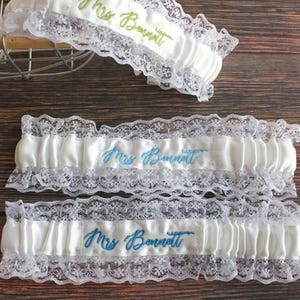 May include: A set of three ceramic mugs with a speckled, matte finish. The mugs are in shades of cream, light gray, and dark gray. Each mug has a simple, minimalist design and a rounded handle.