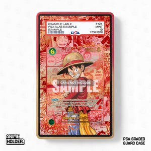 May include: A red and gold PSA graded guard case with a card featuring a manga character. The card has the text "Monkey. D. Luffy" and "SAMPLE". The case has the text "ANIME HOLDER" and "PSA GRADED GUARD CASE".