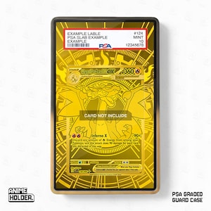 May include: A gold-colored PSA graded guard case with a black frame. The case contains a gold-colored Mega Charizard EX trading card. The card has the text "CARD NOT INCLUDE" and "Inferno X". The case also has a PSA label with the text "EXAMPLE LABLE".