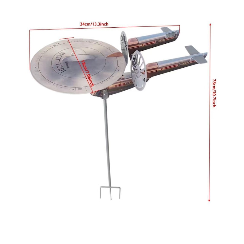 May include: A metal starship garden spinner featuring a circular saucer section with NCC-1701 markings, two cylindrical engine nacelles, and a vertical support stake. Dimensions are 34 cm wide, 18 cm deep, and 78 cm in total height.