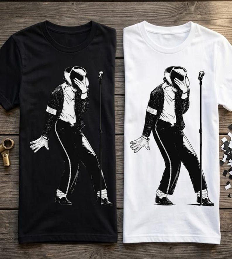 May include: A black t-shirt and a white t-shirt, each featuring a graphic illustration of a performer in a fedora, jacket, and trousers, holding a hand to their face while standing next to a microphone stand on a thin, vertical pole.