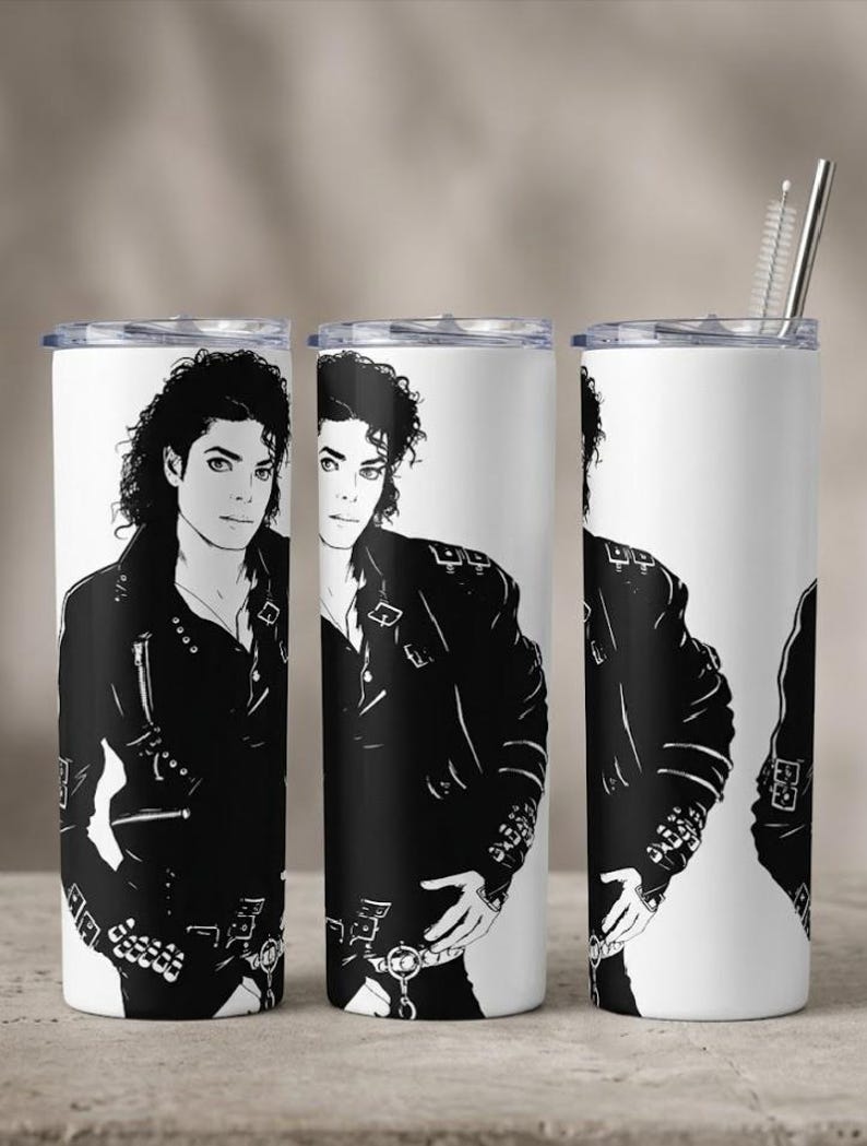 May include: A white cylindrical tumbler featuring a repeating black and white graphic illustration of a person with curly hair wearing a leather jacket with buckles and zippers. The tumbler includes a clear lid and a metal straw with a cleaning brush.