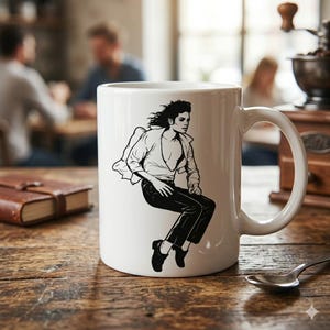 May include: A white ceramic mug featuring a black line art illustration of a person with curly hair wearing a button-down shirt and trousers, captured in a dynamic pose as if jumping or dancing, with a handle on the right side of the mug.