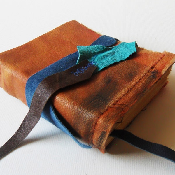 Leather Scraps, blue, orange, brown spontaneous journal. Book Arts 140 pages 4.5x5 inches