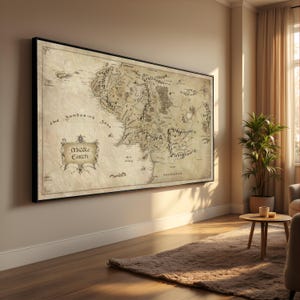 May include: A framed map of Middle Earth, with detailed illustrations of the fictional world. The map is in sepia tones, with the words "Middle Earth" and "The Sundering Seas" visible. The frame is black.