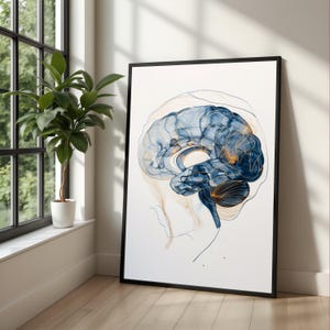 May include: A framed art print featuring a watercolor illustration of a human brain. The artwork uses shades of blue and gold against a white background. The brain is depicted with intricate details and is encased in a black frame.