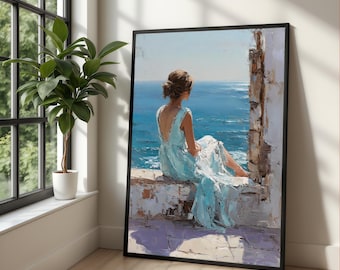 Puede incluir: Impresión artística enmarcada de una mujer con un vestido azul claro, sentada y mirando al mar. La pintura tiene un estilo texturizado e impresionista, con un enfoque en el mar y el cielo. La obra de arte se presenta en un marco negro.