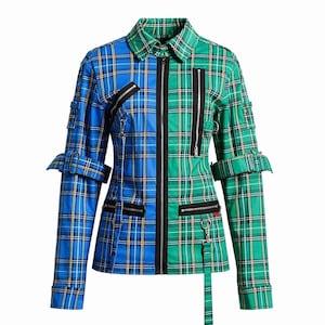 May include: A two-toned plaid jacket, split vertically with blue and green sections. The jacket features black zippers, buckles, and straps. The collar is a classic style, and the sleeves have adjustable cuffs. The overall design is a blend of punk and preppy styles.