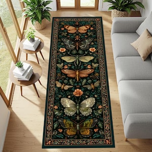 May include: A rectangular dark green rug with a detailed butterfly and floral pattern. The rug features various butterfly illustrations in shades of brown, gold, and green, with orange flowers and a decorative border. The rug is placed on a wooden floor.