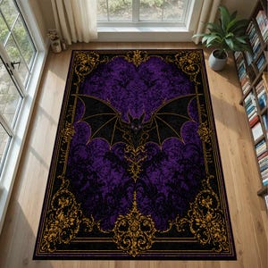 May include: A rectangular area rug with a gothic theme. The rug features a purple background with a black bat design in the center. Gold filigree borders the rug, and the edges are black.