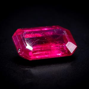 May include: A white ceramic mug with a black handle and the text "But First, Coffee" in a black, bold font. The mug is on a white surface. The mug is approximately 4 inches tall.