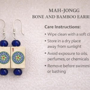May include: Mah-Jongg earrings with bone and bamboo tiles. Each earring features a blue bead at the top and bottom, with a tile in the center displaying a colorful circular design. The text "MAH-JONGG BONE AND BAMBOO EARRINGS" is visible.
