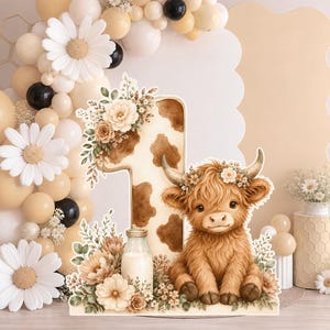 May include: A decorative cutout featuring a large number one with a brown and white cow print pattern, adorned with beige flowers and greenery. Next to it sits a fluffy brown highland calf, a glass milk bottle, and more floral accents.