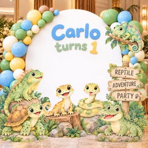 May include: A round white backdrop featuring the text Carlo turns 1, decorated with a balloon arch in blue, green, yellow, and white. Illustrations of a chameleon, iguana, turtle, gecko, snake, and crocodile surround a wooden sign.
