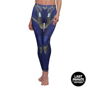 May include: Blue leggings with a futuristic design. The leggings feature a dark blue base with lighter blue and gray accents, creating a high-tech or costume appearance. The design includes geometric shapes and lines.