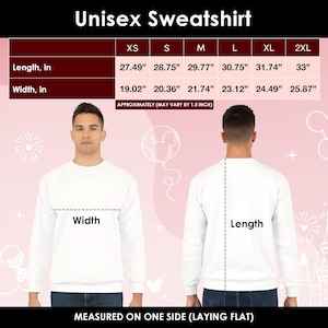 May include: White unisex sweatshirt with size chart. The chart shows length and width measurements in inches for sizes XS to 2XL. The text "Unisex Sweatshirt" is at the top. The image shows a person wearing the sweatshirt.