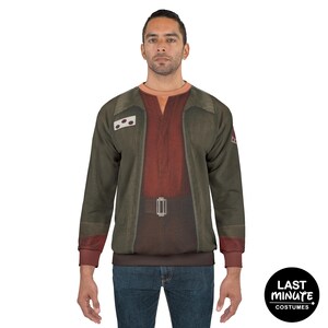 May include: A long-sleeved sweatshirt featuring a costume design. The top has a dark green jacket-like appearance over a red shirt, with a brown belt detail. The sleeves are dark red. The sweatshirt has the text "Last Minute Costumes" on the bottom right.