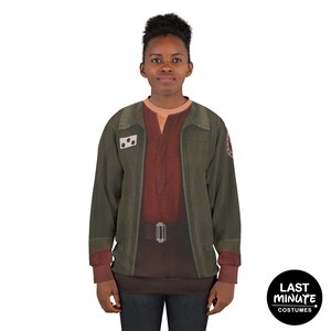 May include: A long-sleeved sweatshirt featuring a costume design with a green jacket, a red shirt, and a brown belt. The sweatshirt has a printed design and the words "Last Minute Costumes" in a black circle.