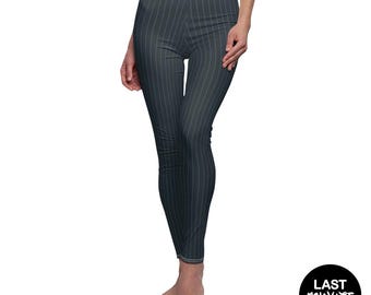 May include: Full-length leggings in a dark charcoal grey colour featuring a vertical white pinstripe pattern. The leggings have a high-rise waistband with visible stitching detail along the top edge and a slim, form-fitting silhouette.