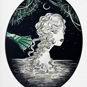 May include: An illustration of a woman with long, wavy, light-colored hair emerging from water. A green, clawed hand reaches towards her. The background is dark with a crescent moon and stars, framed by an oval border with foliage.