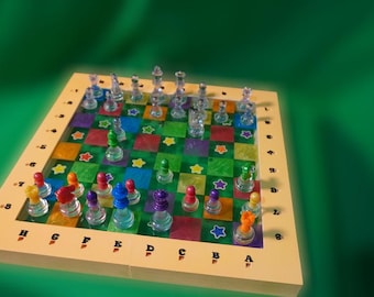 May include: A colorful chess set with clear glass pieces and a vibrant game board. The board features squares of various colors, including green, purple, and orange, with star accents. The chess pieces are in various colors, including red, blue, and yellow.