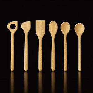 May include: A set of six wooden kitchen utensils, including a slotted spoon, spatula, and various spoons. The utensils are made of light-colored wood and are arranged against a black background.