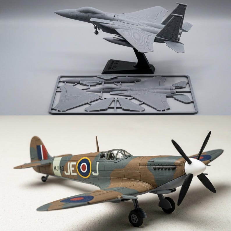 May include: A gray plastic model fighter jet on a black stand with an unassembled parts sprue, and a painted model propeller plane with brown and green camouflage, British roundels, and the identification code MJ143 JE-J on the side.