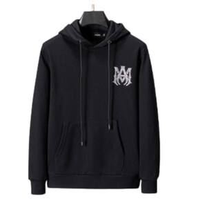May include: Black hooded sweatshirt with a front pocket and a drawstring. The sweatshirt features a white emblem on the upper left chest. The hoodie is hanging on a black hanger.