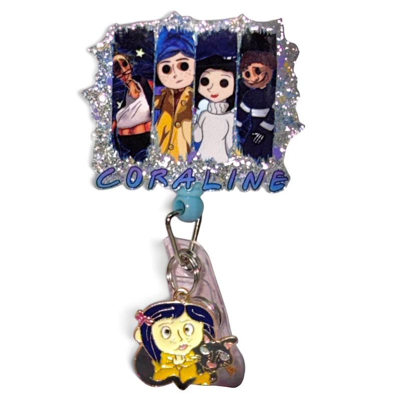 May include: A badge reel featuring a rectangular glittery topper with four character illustrations and the text CORALINE in blue letters. A small metal charm of a character with blue hair and a black cat hangs from the retractable cord below.